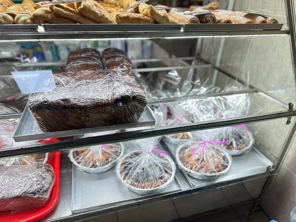 Vitrina cu foietaje, cozonaci ambalați și plăcinte la tavă